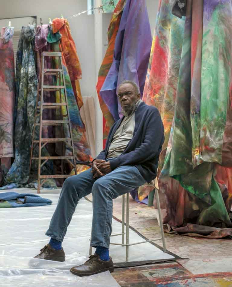 The artist Sam Gilliam in his studio in Washington on May 17, 2018. Gilliam, a pioneering abstract painter best known for his lusciously stained Drape paintings that took his medium more fully into three dimensions than any other artist of his generation, and who in 1972 became the first Black artist to represent the United States at the Venice Biennale, died on Saturday, June 25, 2022, at his home in Washington. He was 88. (Gabriella Demczuk/The New York Times)